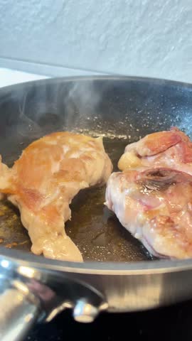 A pan of meat is cooking in a skillet. The meat is browning and he is well-cooked