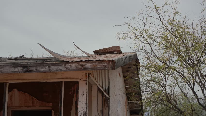 Roof tin flapping in the wind on a decrepit building