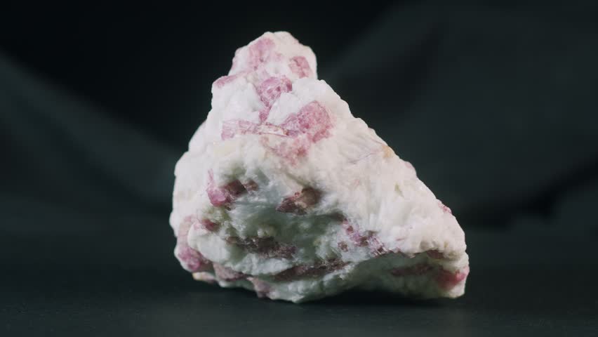 Pink tourmaline rubellite in snow quartz on black background