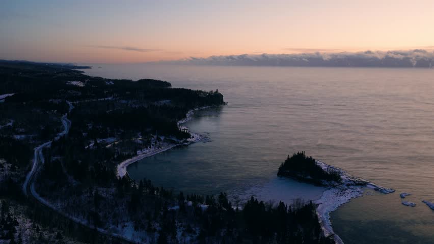 Wide aerial view of the Minnesota North Shore wilderness and Lake Superior islands on a frozen winter morning.