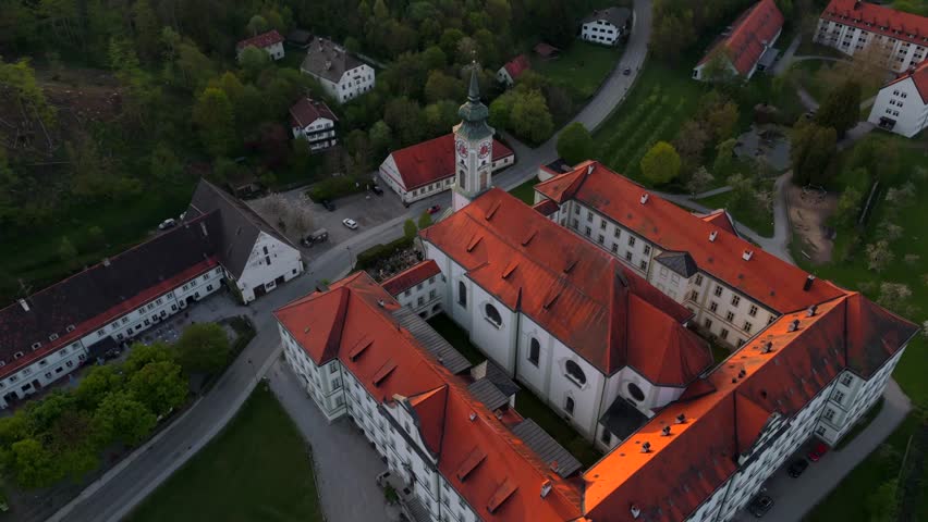 Aerial view of Kloster Schaeftlarn and Praelatengarten park in Bavaria, Germany. Baroque Benedictine abbey and landscaped park in spring, surrounded by meadows and the Isar valley, south of Munich. 