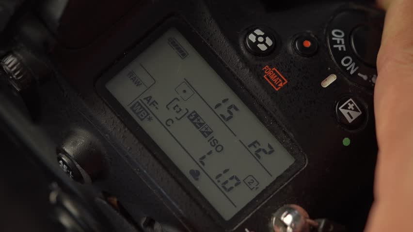 Close-up of a dslr camera's top lcd screen showing the aperture and shutter speed adjustment