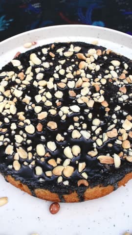Chocolate peanut cake at rotating table, vertical video