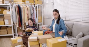 Asian women small business partners organize online shopping parcel box together, checking order sequence, coordinating home based e-commerce packing workflow, managing daily online seller - Powered by Shutterstock - Get 15% off with code: PIKWIZARD15