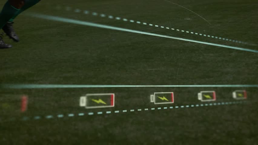 Animation of low,battery, warning over legs of diverse male soccer players at sports field. sport, competition and technology concept digitally generated video.