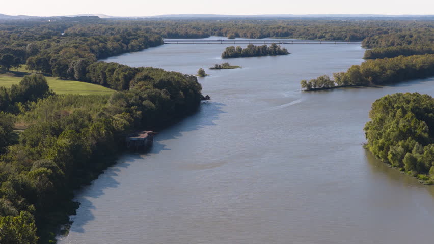 Arkansas River winding by woods in autumn season with Morrison Bluff Bridge, Cane Creek Recreation Area, aerial overview