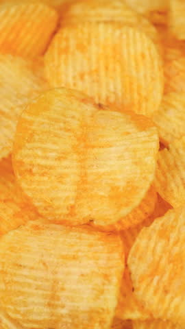 Crispy Potato chips close up, rotate. Potato snack for unhealthy fast food