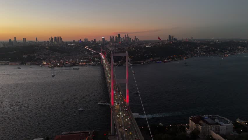 Night aerial view of 15 July Martyrs Bridge with city lights and Bosphorus traffic, Istanbul, Turkey.