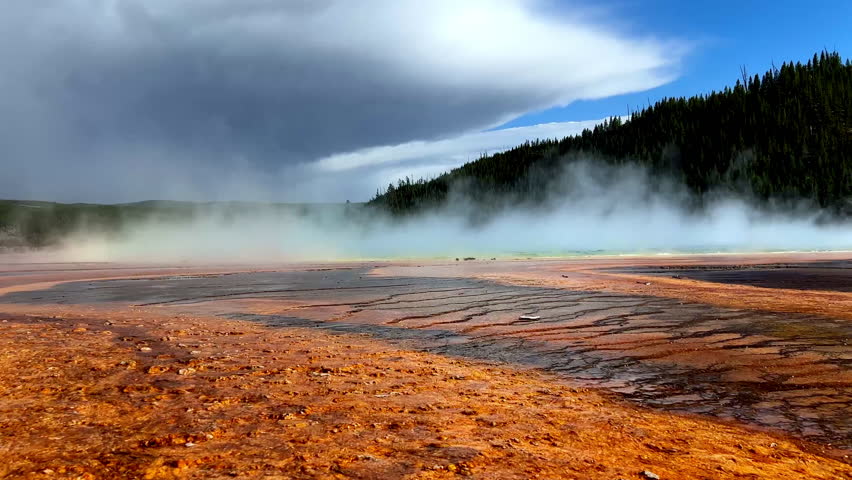 yellowstone national park hot water red orange grand prismatic midway basin geyser steam rising wyoming united states
