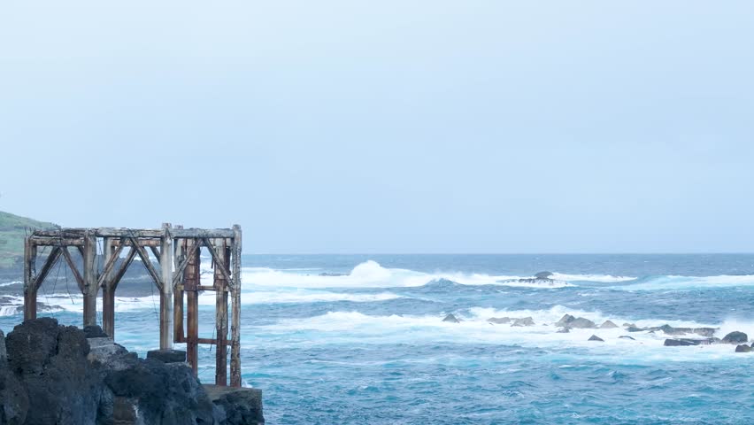 Rough ocean waves crashing on rocky coast