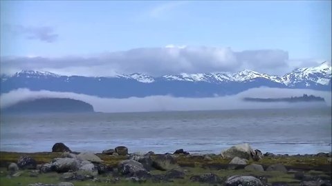 Islands near Petersburg Alaska are shrouded in fog as seen from Sandy Beach Park.