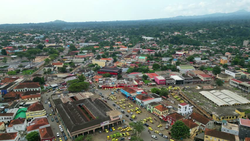 Circular aerial view over the market area and taxi rank in the city of São Tomé, with the coast in the background.Sao Tome e Principe,Africa