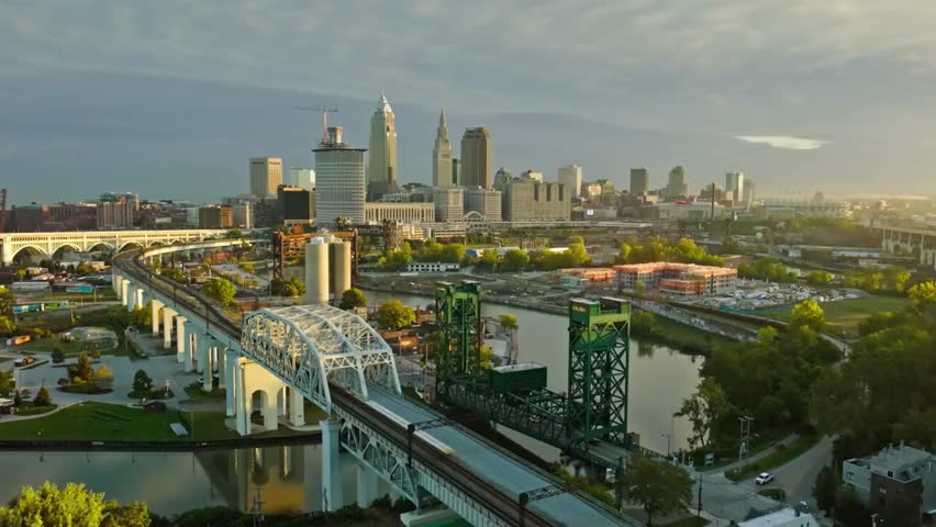 Aerial view of Cleveland skyline at sunrise, featuring bridges over the Cuyahoga River, perfect for cityscape, travel, and urban projects.