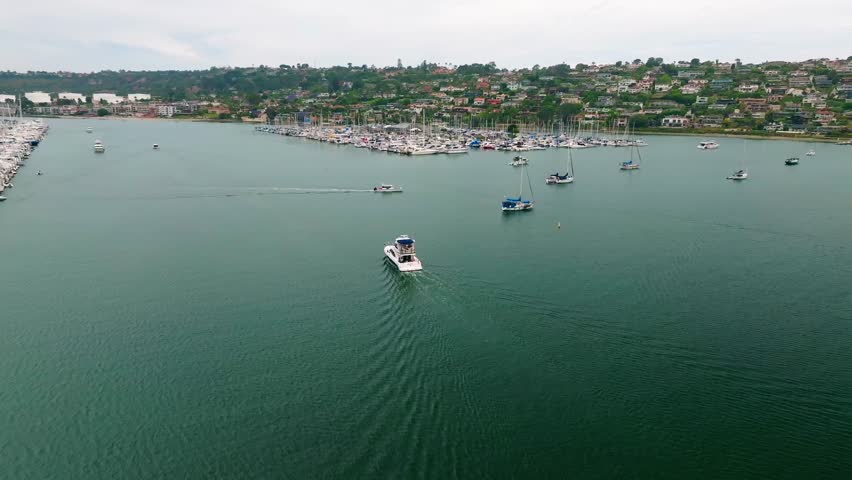 60FPS Orbiting Drone Footage of Boat Exiting the Harbor at Shelter Island, in San Diego, California, USA