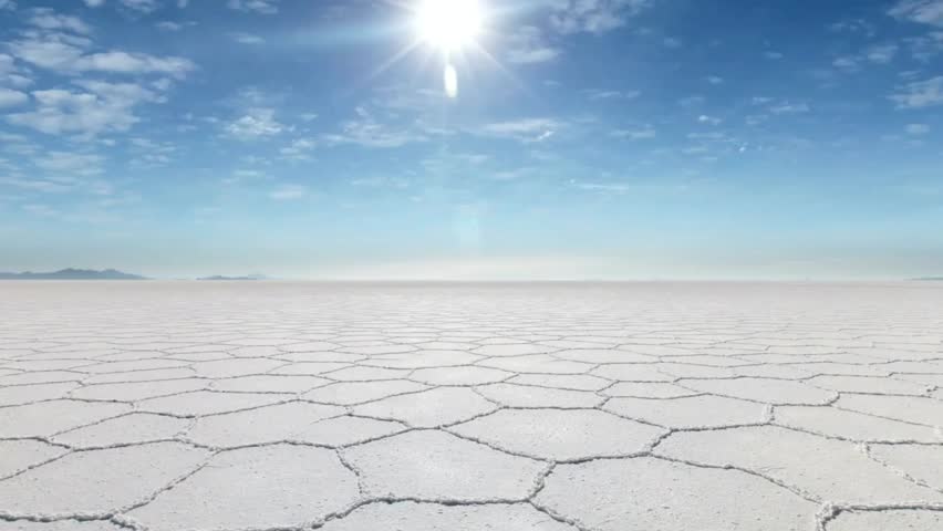 Salar de Uyuni salt flat in Bolivia under a bright sun, showcasing vast reflective landscapes and stunning natural beauty.