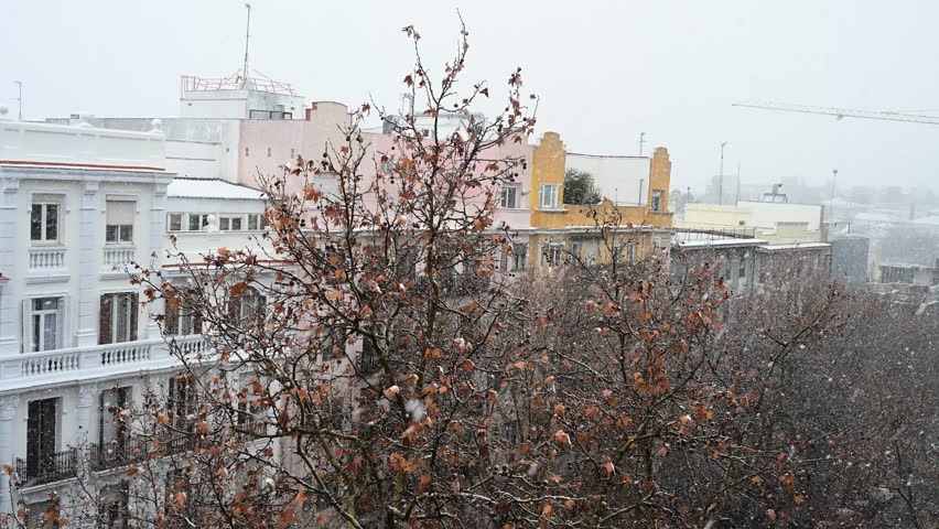 Madrid snowstorm cityscape, Spain: Heavy snow falls on the Spanish capital