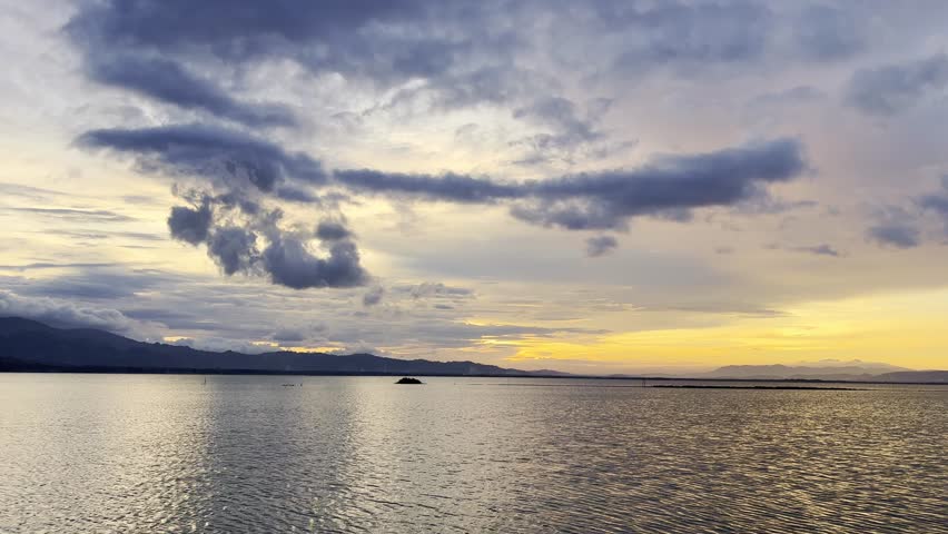Serene Lake at Sunset with Dramatic Clouds
