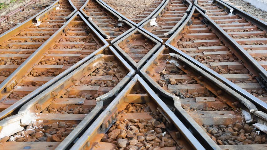intersecting train tracks symbolizing choice direction and transport