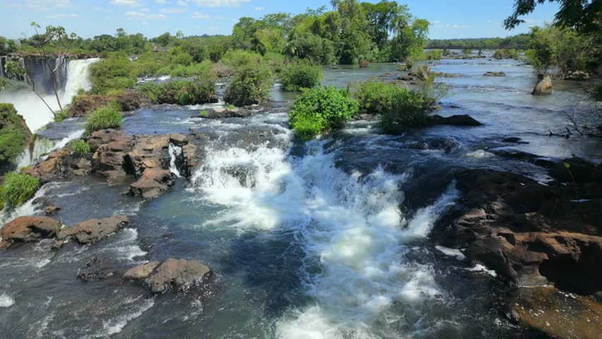 Iguazu Falls cascading over rocks, flowing water creating foam and movement in Iguazu National park, Argentina