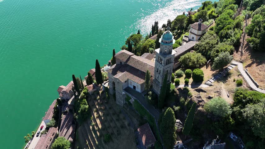 Drone view over Morcote village and church "Maria del Sasso" with the many cypresses at Lake Lugano during Summer, Ticino, Switzerland