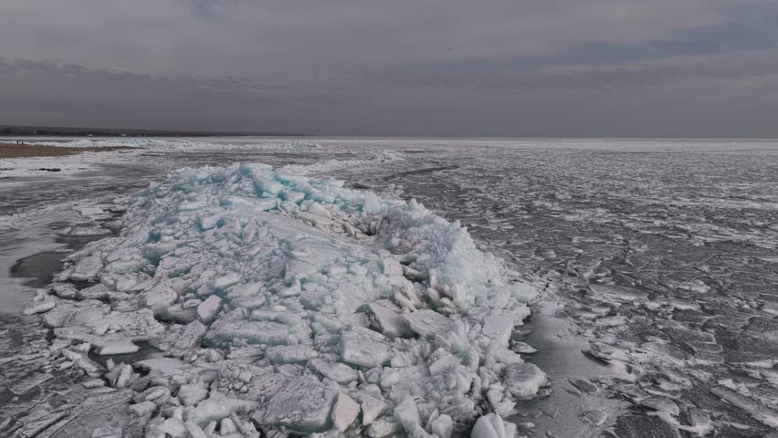 Hummocks on the Kapchagai reservoir. Ice blocks covering the lake. Winter time. The view from the drone.