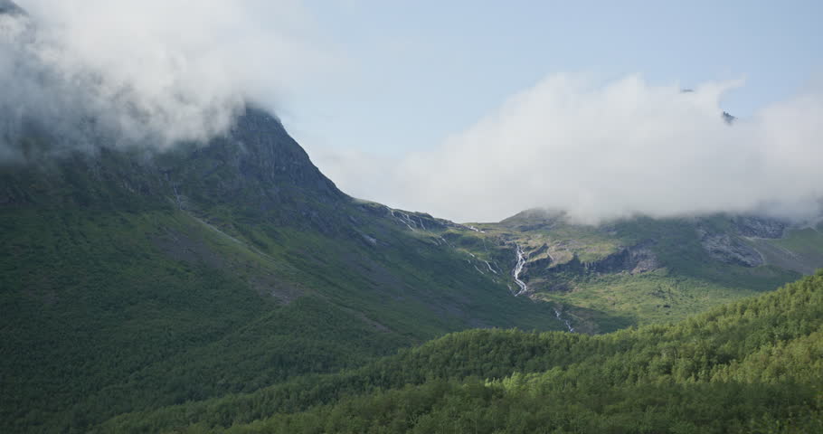 Norwegian majestic green mountains landscape with waterfall