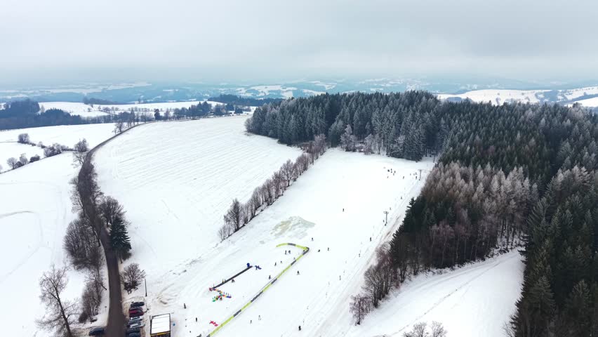 Aerial View of Snowy Hillside in Winter Landscape