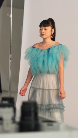 BTS, photoshoot and styling with woman in studio for advertising campaign or fashion magazine. Getting ready, handbag or photography with model and stylists on set for catalog or production session