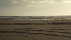 Still beach with wet sandy trace and dark sea waves shining under dramatic sunset rays - Powered by Shutterstock - Get 15% off with code: PIKWIZARD15