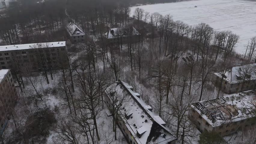 Drone footage of abandoned Soviet-era military buildings near Leipzig, Germany. Snow-covered ruins stand hidden in a forest, revealing a forgotten Cold War site in winter.