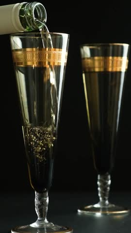 Slow Motion Pouring White Wine into Elegant Glass with Gold