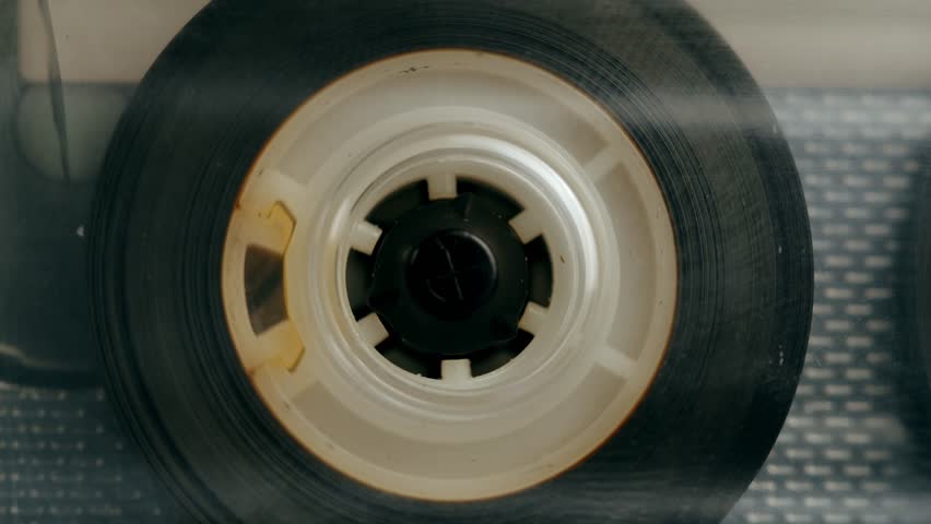 Retro radio tape recorder, audio cassette close-up. Listening to music, old radio boom box player, macro of vintage music listening. 