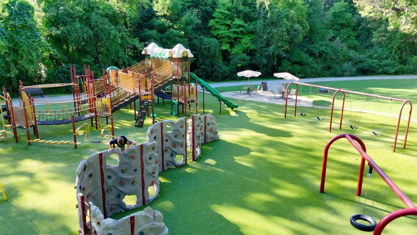 Kid climbing a wall at Prairie Creek Park in Brownstown, Michigan, USA