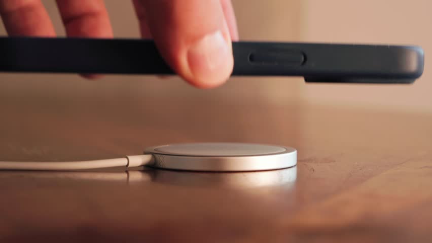 Wireless charging smartphone. Close-up of mobile phone charging with charging. High quality 4k footage