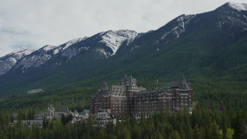Fairmont Banff Springs hotel nestled in snowy Rocky Mountains in Banff National Park