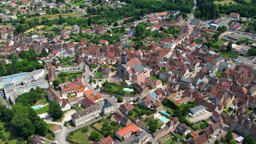 A panoramic aerial view around the old town of the city Arnay-le-Duc in France on a cloudy spring noon