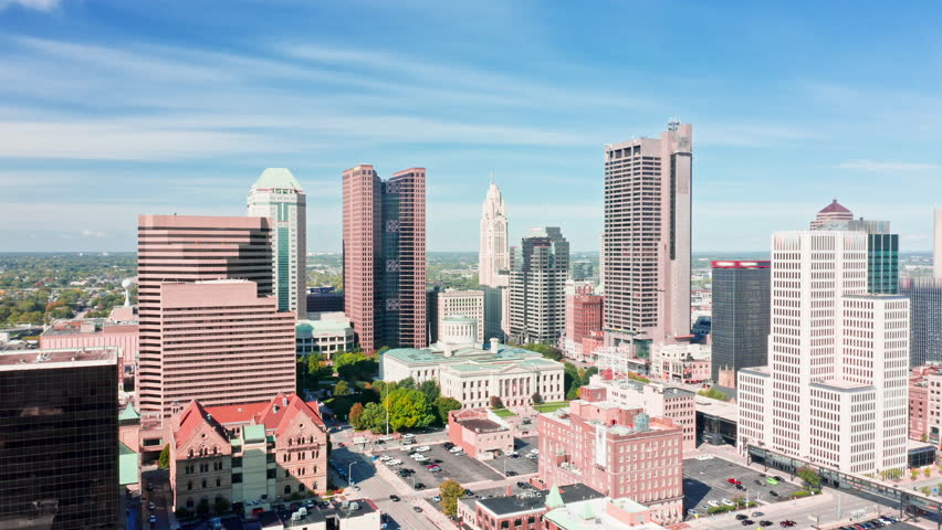 Aerial revealing shot of the Ohio State House and Columbus skyline with slow camera approach towards the Capitol