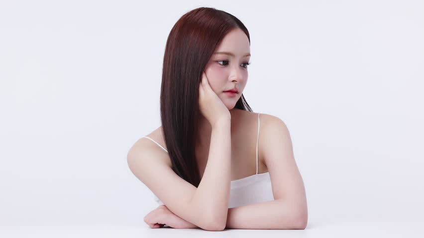 Slow motion portrait beautiful young Asian woman with K beauty style makeup and perfect skin. Facial and skin care concept for commercial advertising.