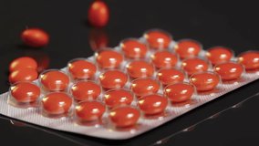 Red Sugar-Coated Pills tablets falling onto blister pack and colliding suggesting medication or medicine pharmaceutical themes, health, healthcare, treatment, and medical care - Powered by Shutterstock - Get 15% off with code: PIKWIZARD15