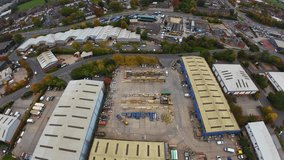 Aerial View Industrial Warehouse Yard Storage, Drone Captures Rooflines, Loading Bays, Parked Trucks, Stacked Containers, Concrete Lot, Adjacent Suburban Roads And Green Trees Overcast Sky Highangle - Powered by Shutterstock - Get 15% off with code: PIKWIZARD15