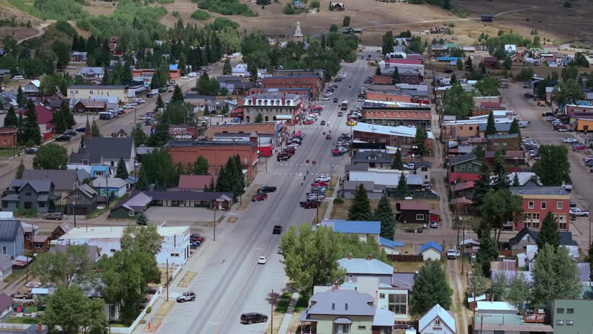Silverton Colorado town center surrounded by expansive alpine landscape, aerial telephoto, Colorado USA