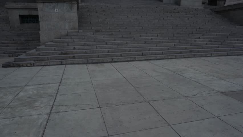 Camera tilts up showing a gray neoclassical building which is called "Palacio de Justicia". The Peruvian Supreme court. Located in Lima, Peru.