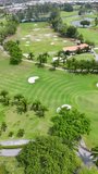 High angle drone shot moves over a tropical golf course with sand bunkers and palms - Powered by Shutterstock - Get 15% off with code: PIKWIZARD15