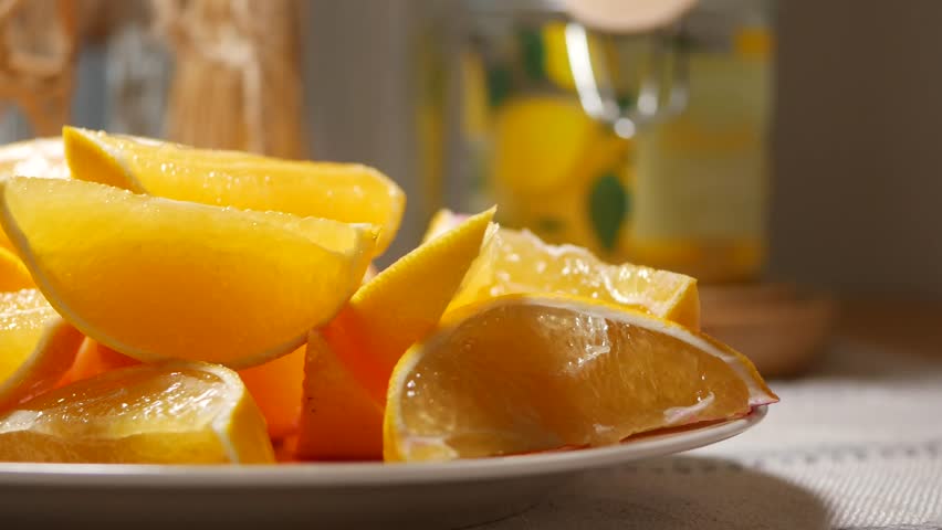 Close up of fresh orange slices on a plate, preparing for juicing or serving