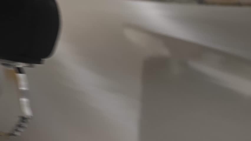 Dramatic ice-level close-up: a skate blade slices through the ice with motion blur, capturing the power and elegance of figure skating training.