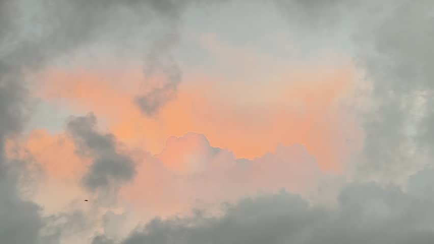 a dramatic cloudscape with a sunset breaking through dark, heavy storm clouds