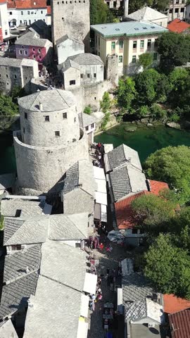 A drone flies over the Old Bridge and the Old Town in Mostar, Bosnia and Herzegovina