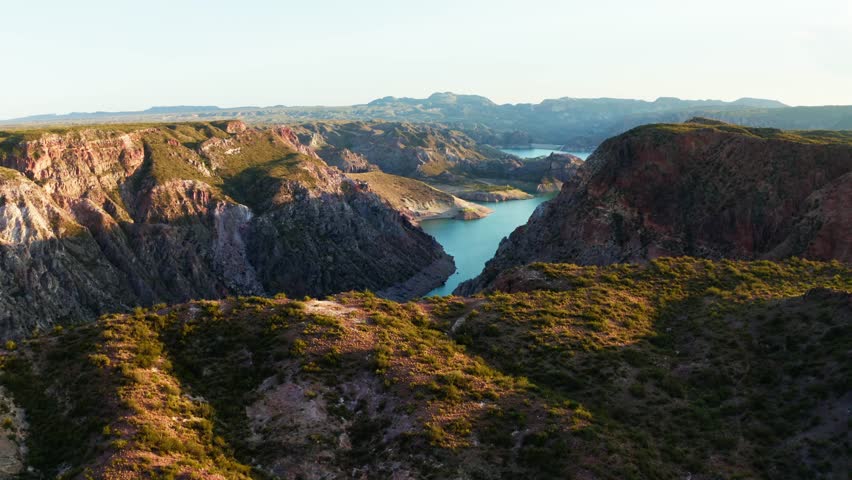 Wide aerial reveal of river bend cutting through dramatic Canon del Atuel canyon, Mendoza Argentina