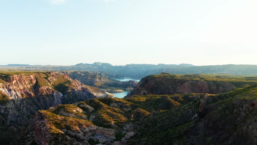 Wide aerial dolly reveals canyon opening into expansive desert valley, Canon Del Atuel, Mendoza Argentina