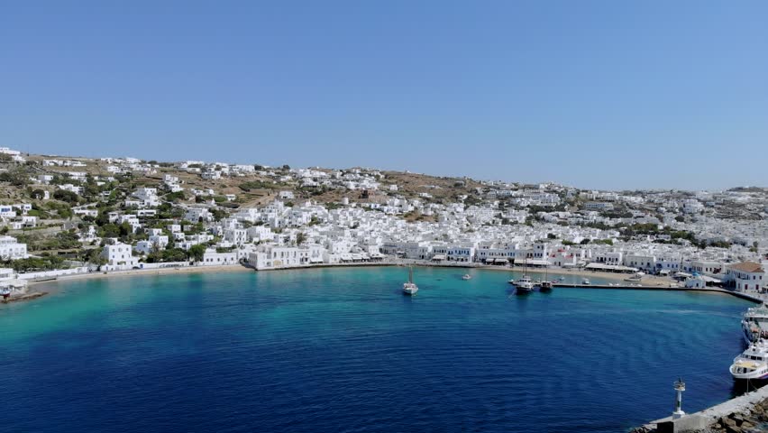 Explore the breathtaking beauty of Mykonos, Greece, with its vibrant blue waters and iconic white architecture. The sun-kissed landscape invites relaxation and adventure in this stunning destination.